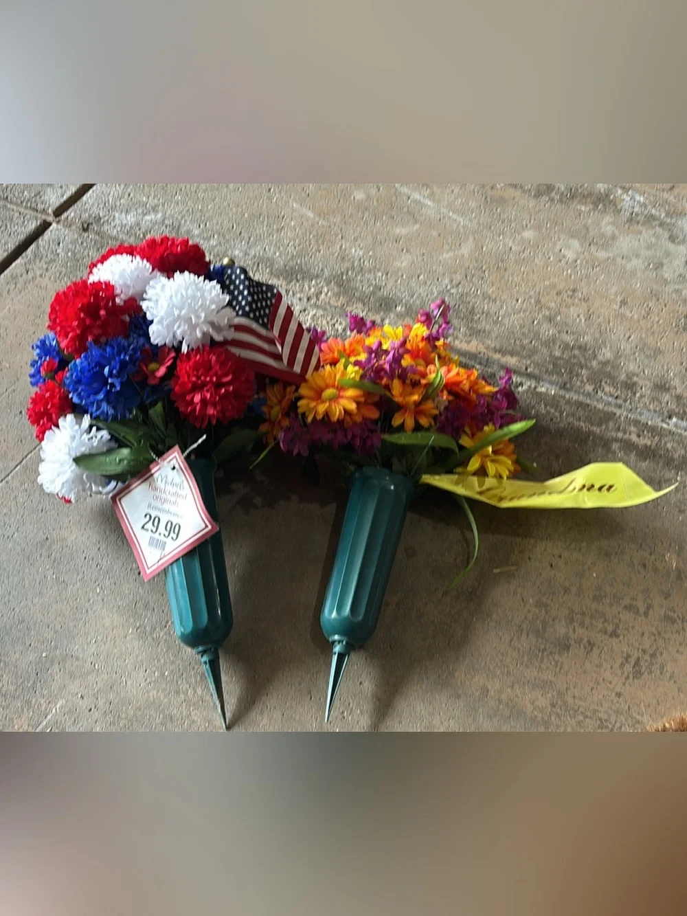 Gravesite flowers brand new: one red white and blue and grandma tags.